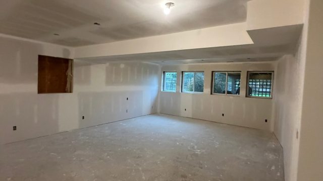 Residential drywall finishing with new windows and ceiling lights