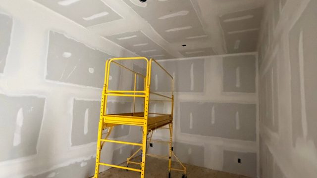 Hung drywall on walls and ceiling in a residential renovation